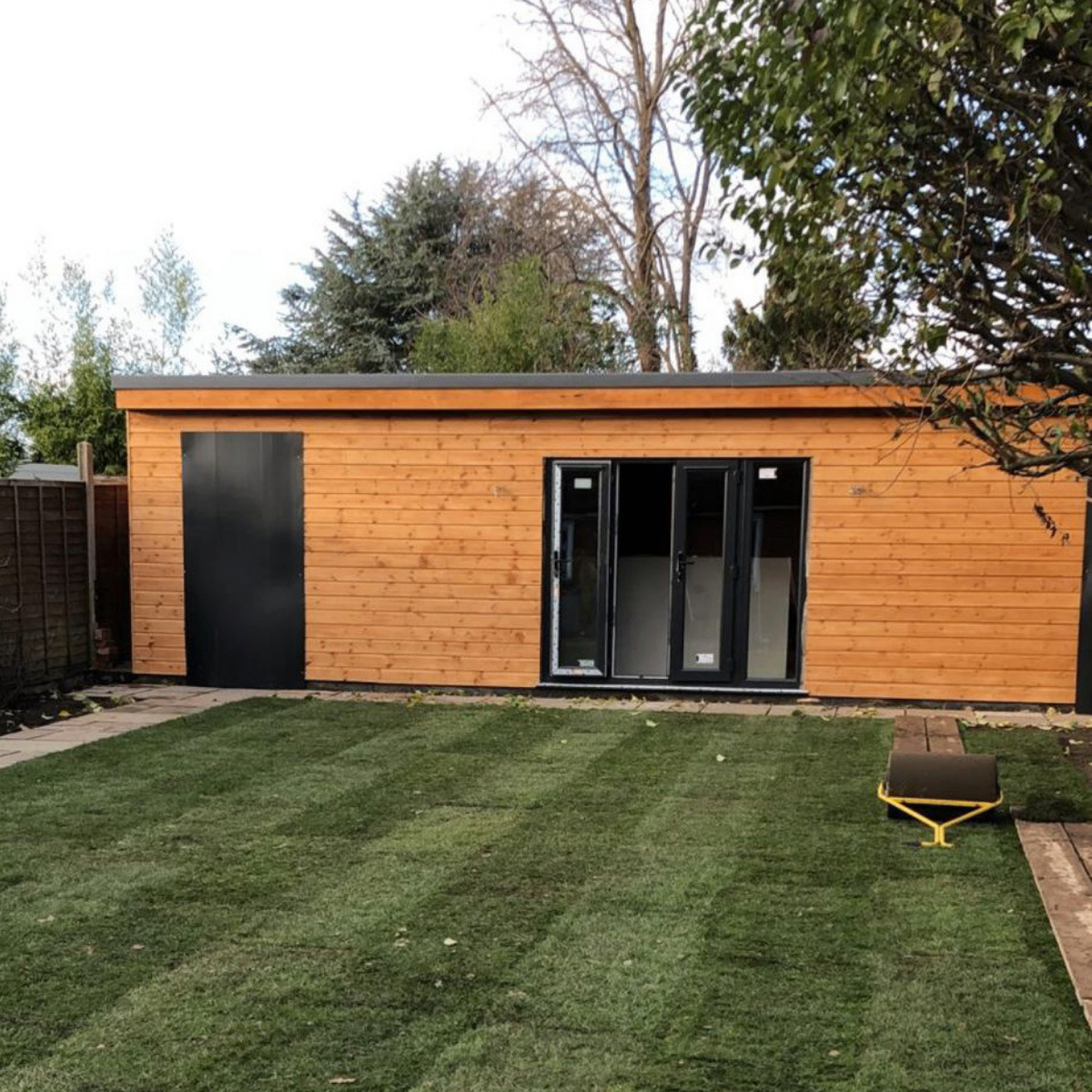 Bespoke cedar-clad garden room with anthracite bifold doors