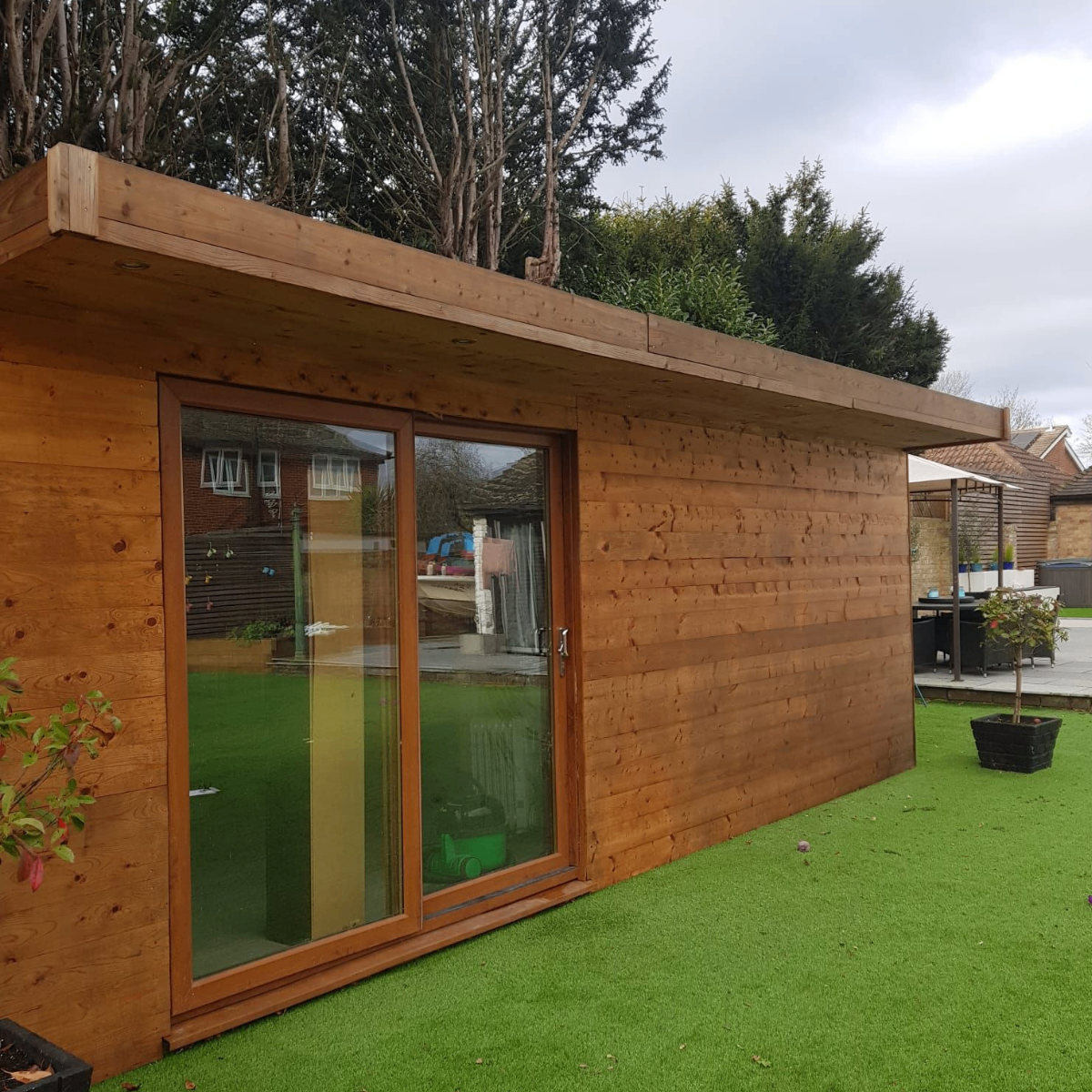 Side view of a timber garden room with large sliding glass door