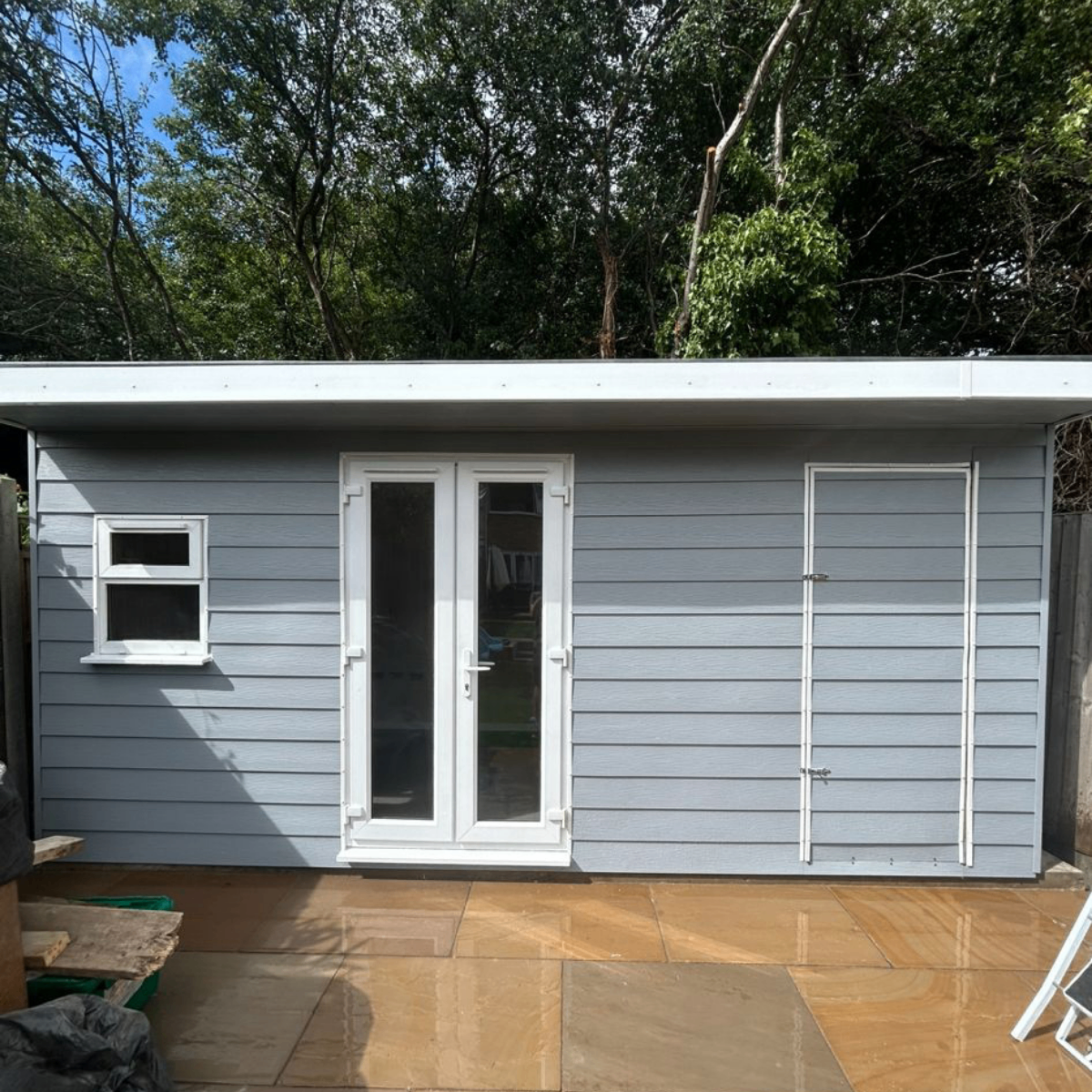 Grey clad bespoke garden room with patio